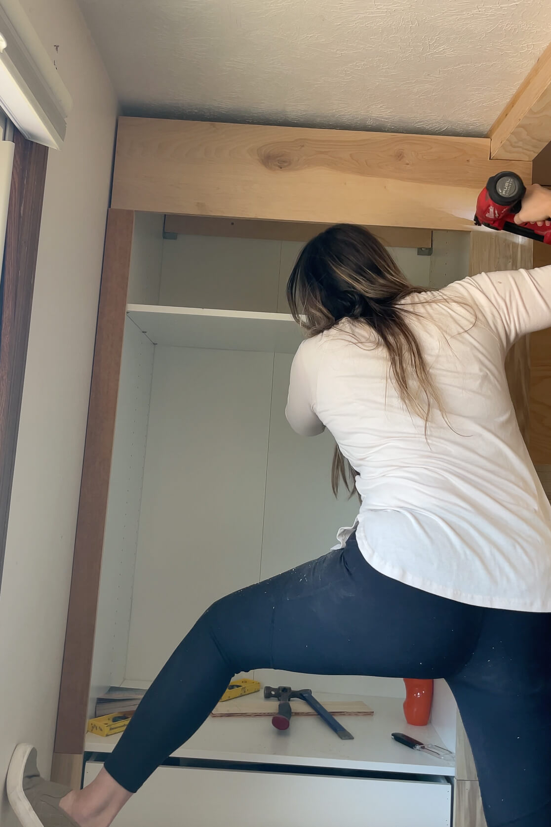 Building DIY bunk beds in a kid's room makeover.